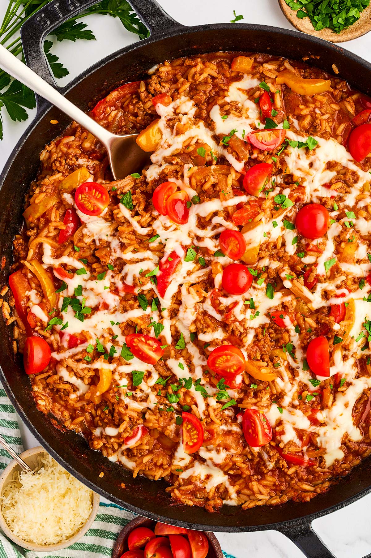 Overhead close up view of a skillet with unstuffed peppers.