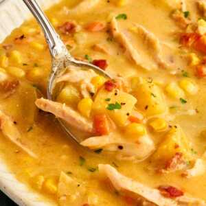 Spoon in a bowl with corn chowder.