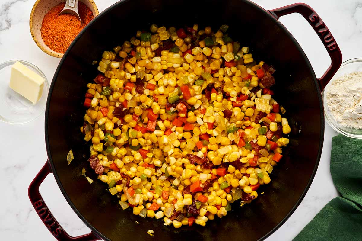 Sautéing vegetables in a cast iron pot.