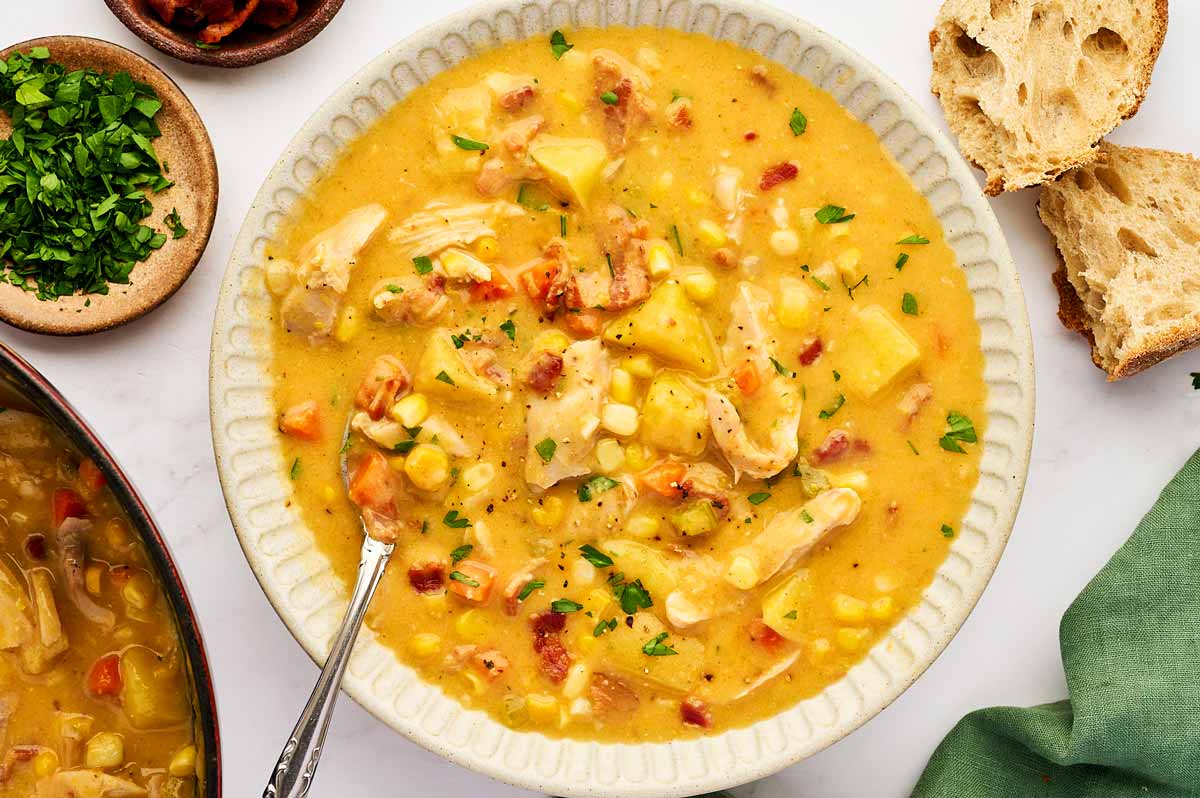 Bowl with corn chowder and bread.