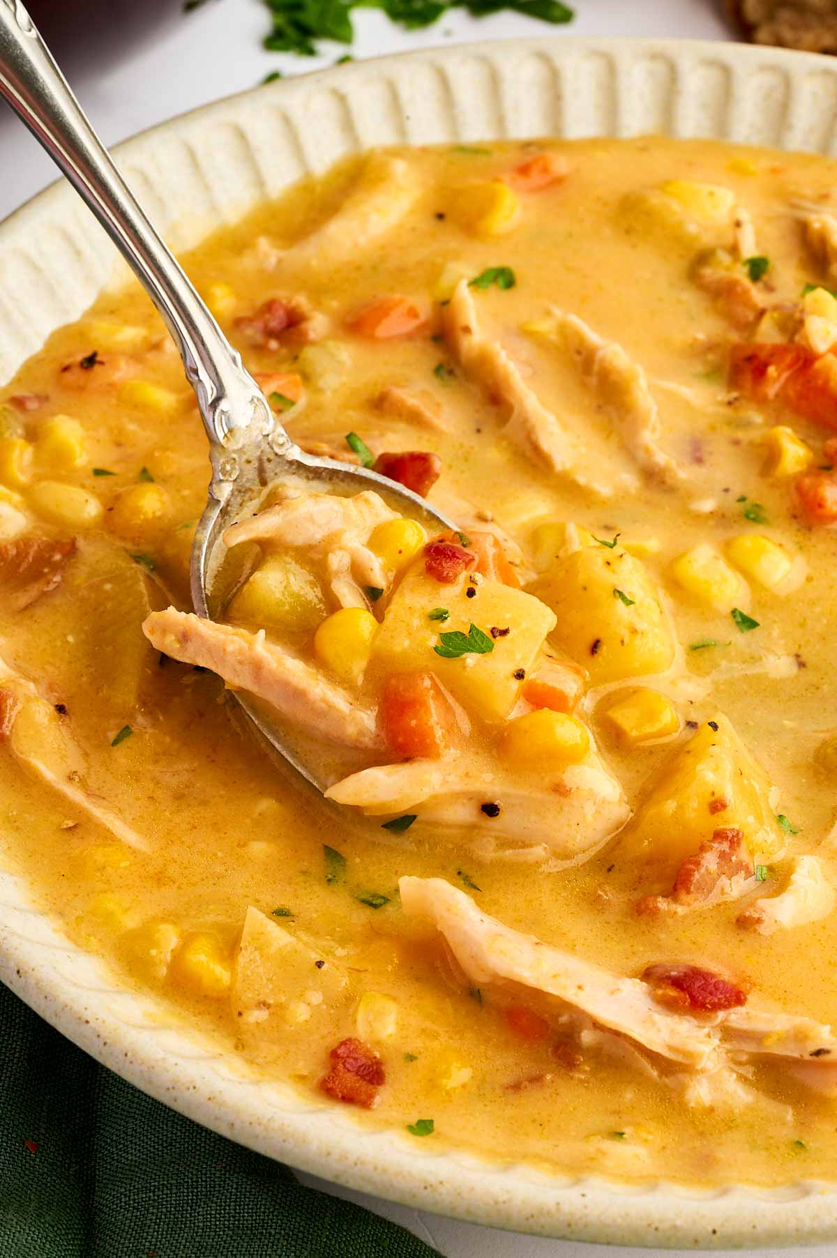 Spoon in a bowl with corn chowder.