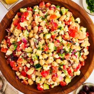 Wooden salad bowl with greek chickpea salad.