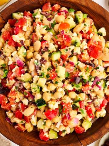 Wooden salad bowl with greek chickpea salad.
