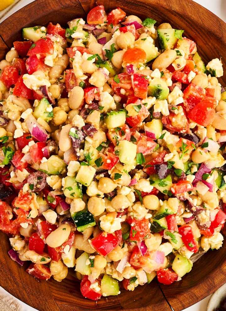 Wooden salad bowl with greek chickpea salad.