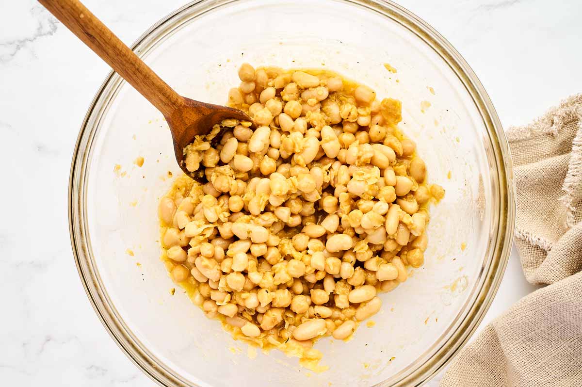 Marinating chickpeas and beans in Greek salad dressing.