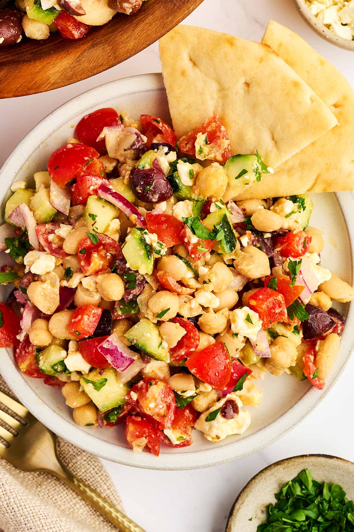 Plate with chopped Greek Chickpea Salad and pita bread.