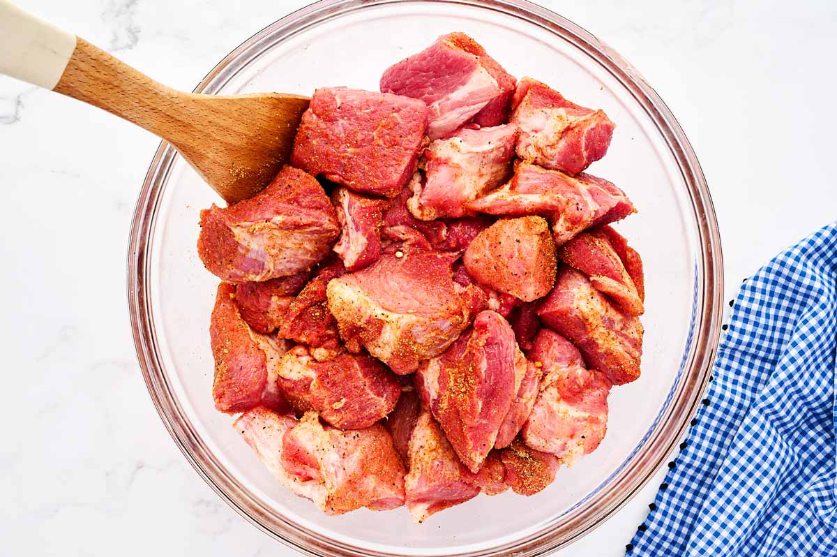 Seasoned pork cubes in glass bowl.