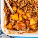 Overhead view of peach crisp with the peaches showing under the topping.