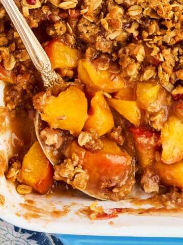 Overhead view of peach crisp with the peaches showing under the topping.