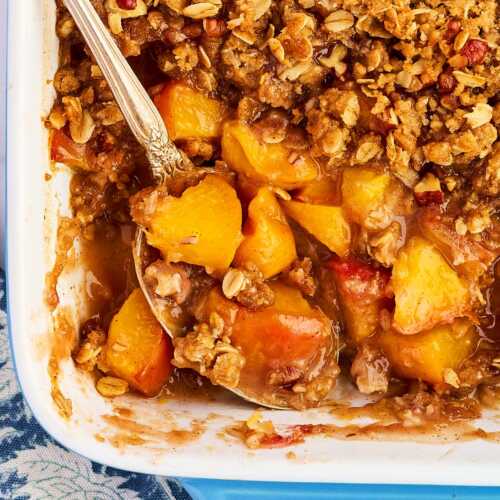 Overhead view of peach crisp with the peaches showing under the topping.