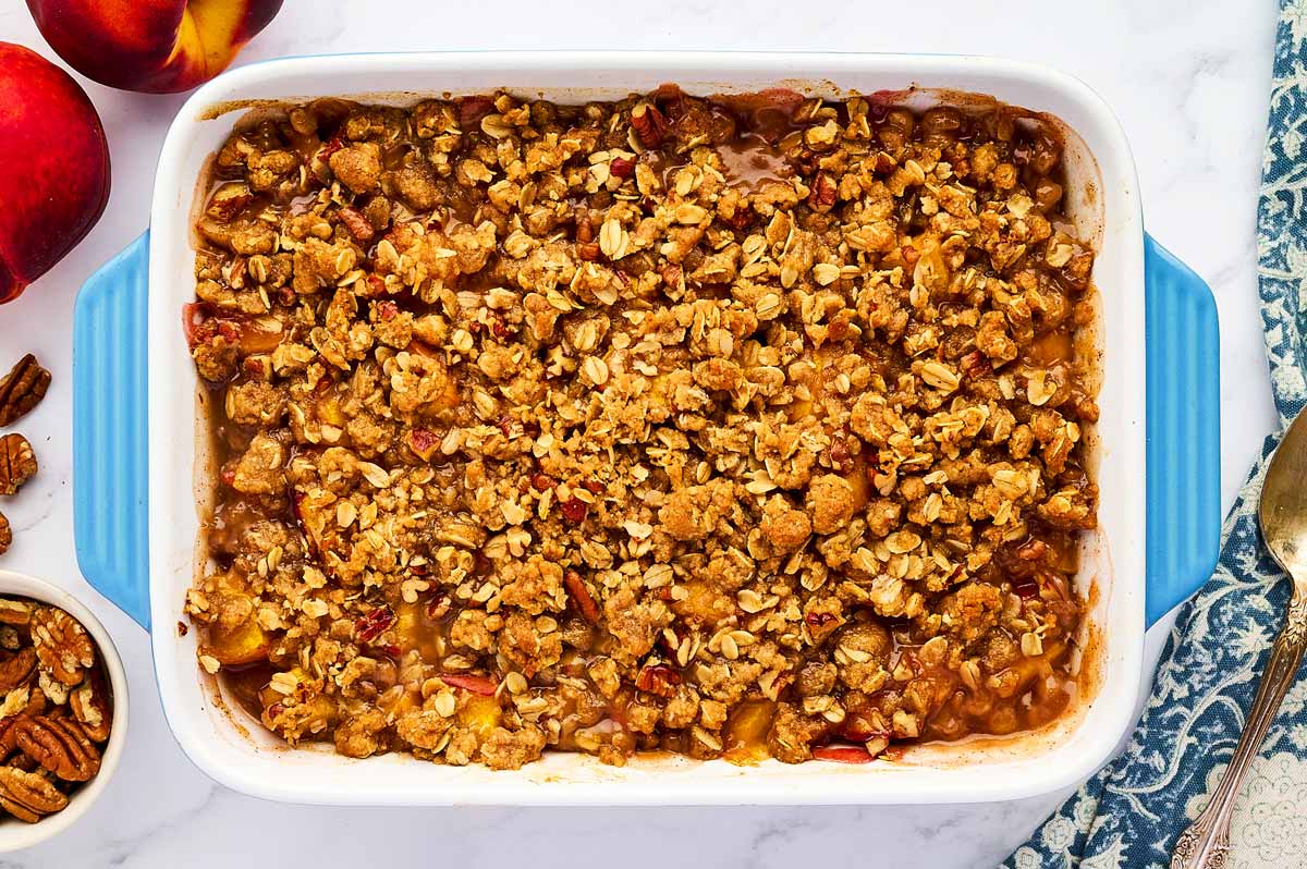 Baked Peach Crisp in a blue casserole dish.