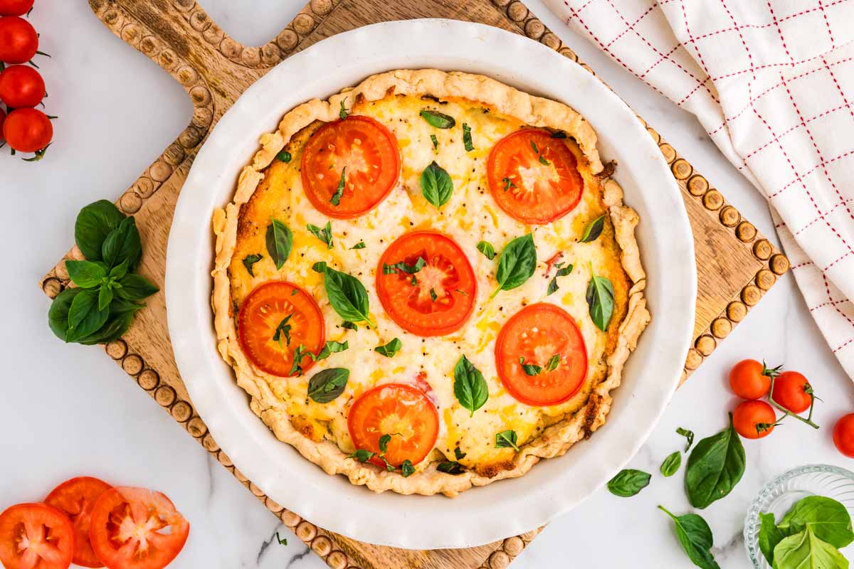 Baked tomato pie on a wooden board.