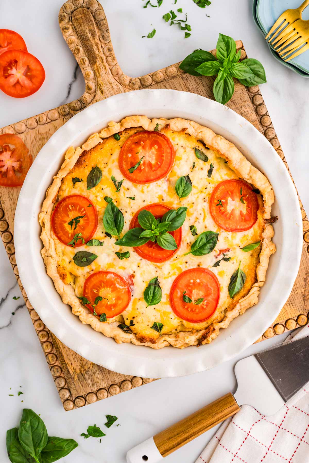 Baked tomato pie on a wooden board.