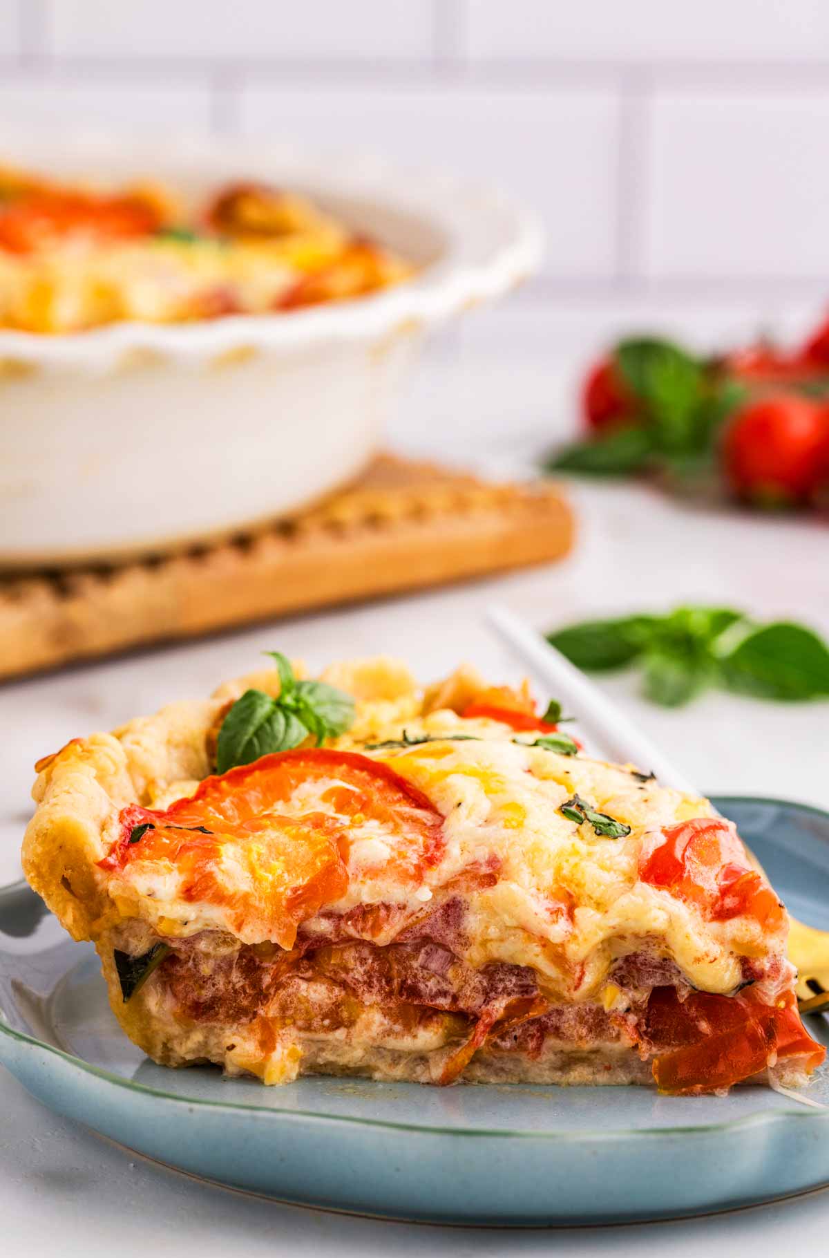 Slice of tomato pie on a plate.