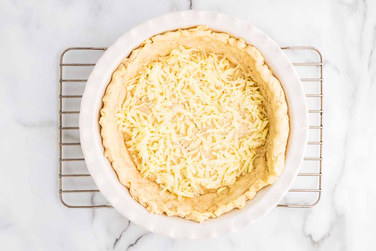 Shredded mozzarella in par-baked pie crust.