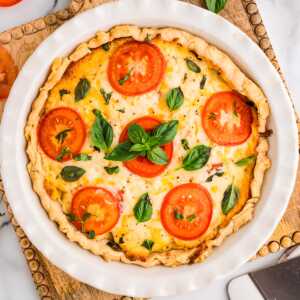 Baked tomato pie on a wooden board.