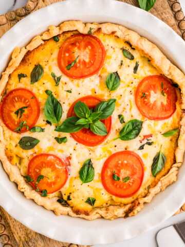 Baked tomato pie on a wooden board.