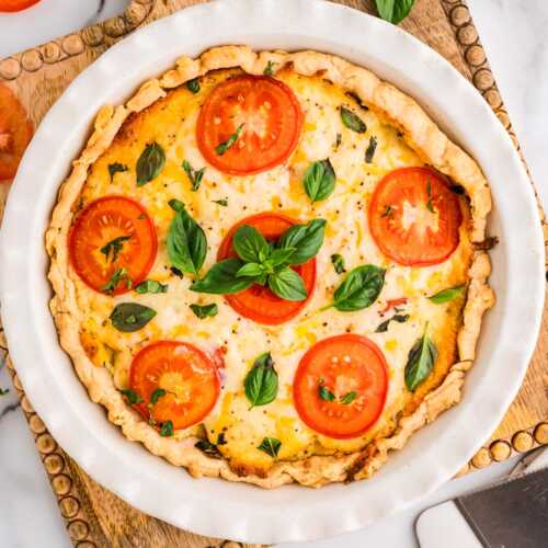 Baked tomato pie on a wooden board.