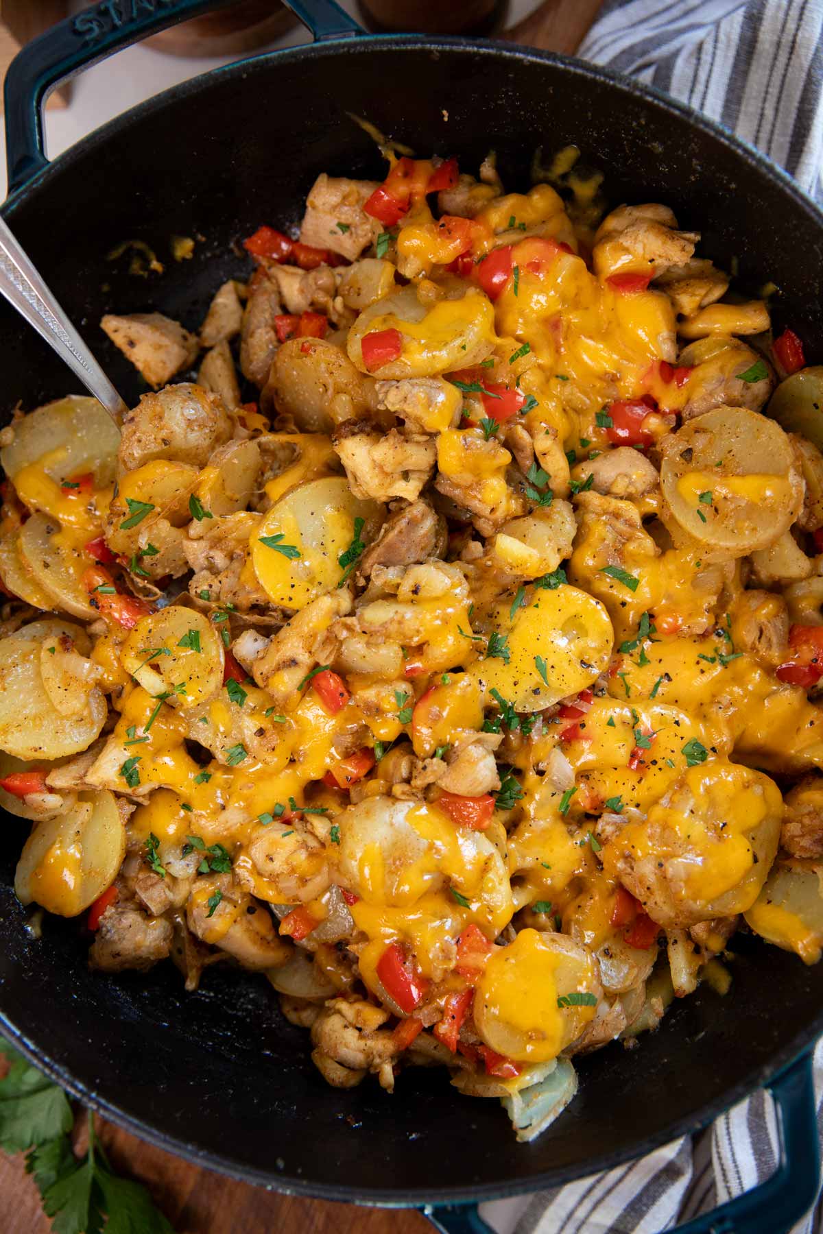 Overhead view of cajun chicken and potatoes in a cast iron skillet.