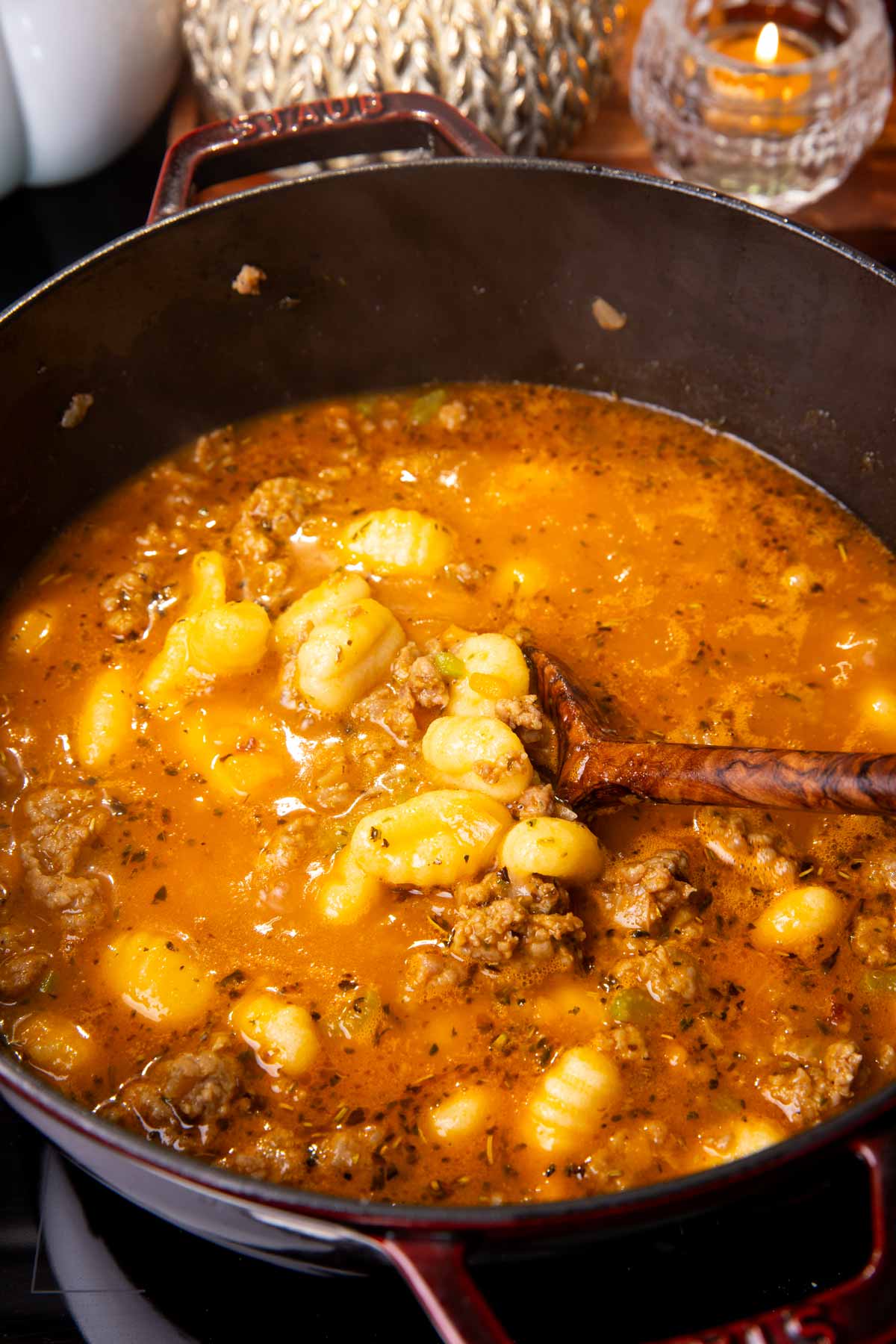 Soup with gnocchi in cast iron pot.