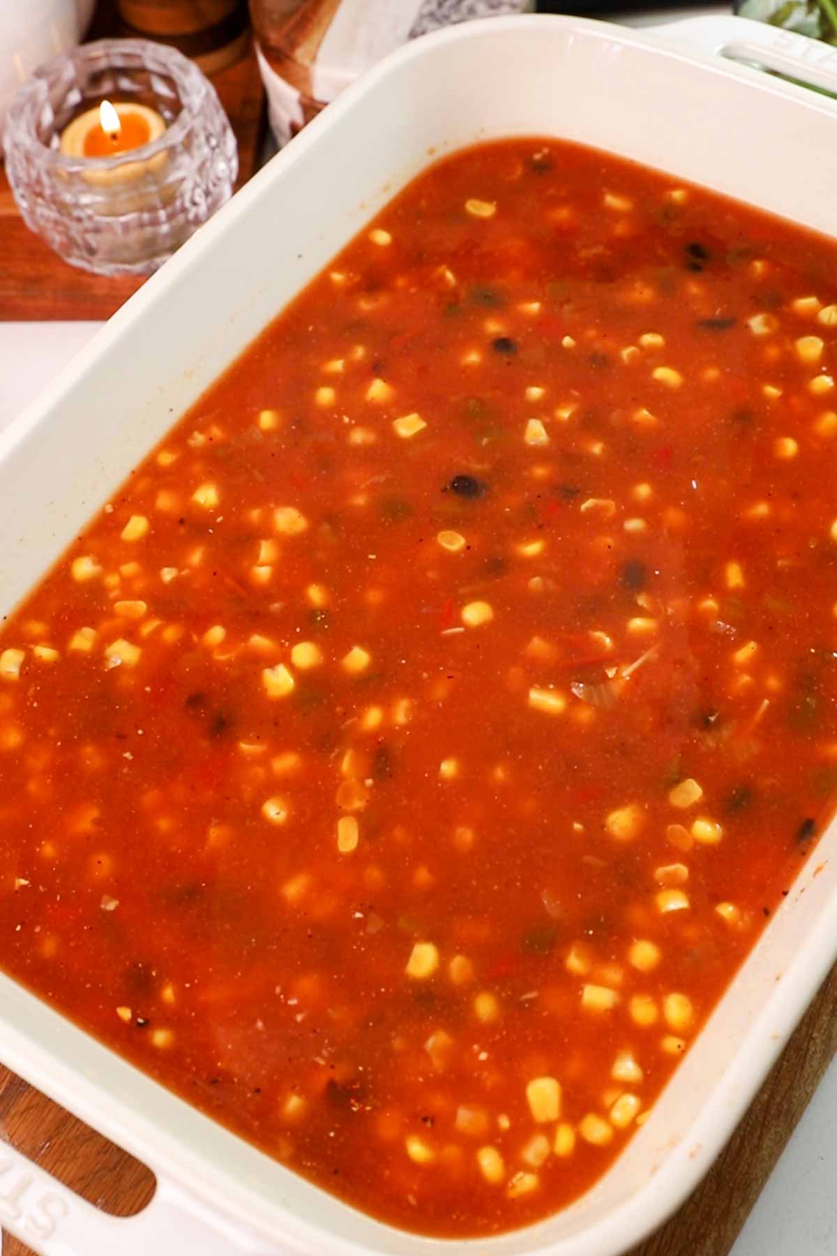 Salsa, beans and corn in casserole dish.