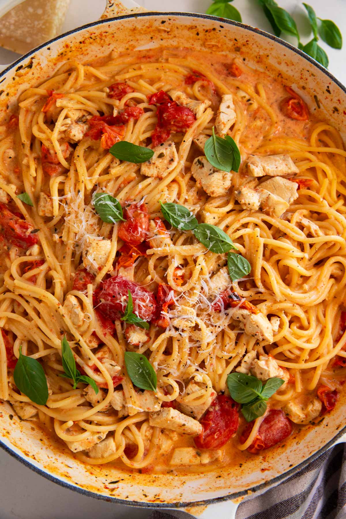 Overhead view of pan with tomato basil chicken pasta.