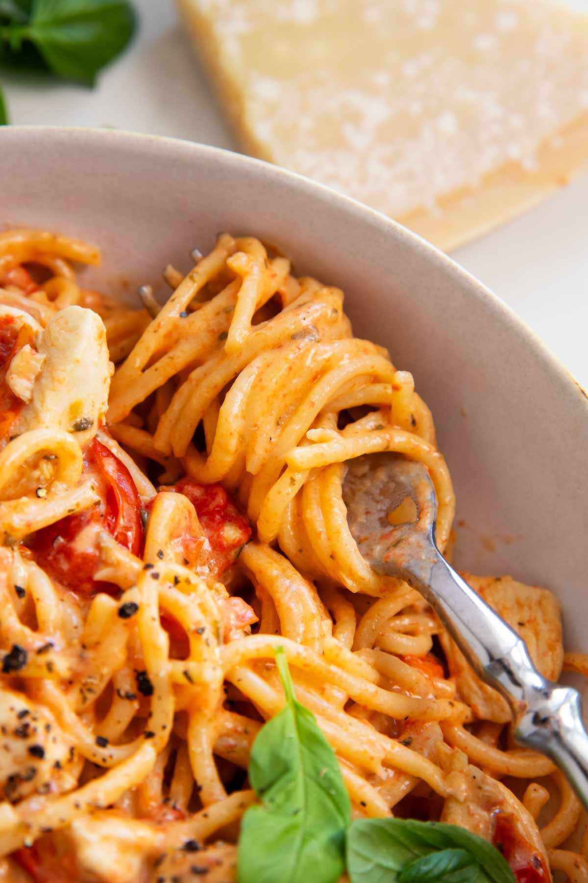 Close up of a fork with spaghetti twirled around it.