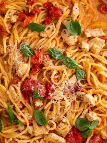 Close up photo of cherry tomato chicken pasta.