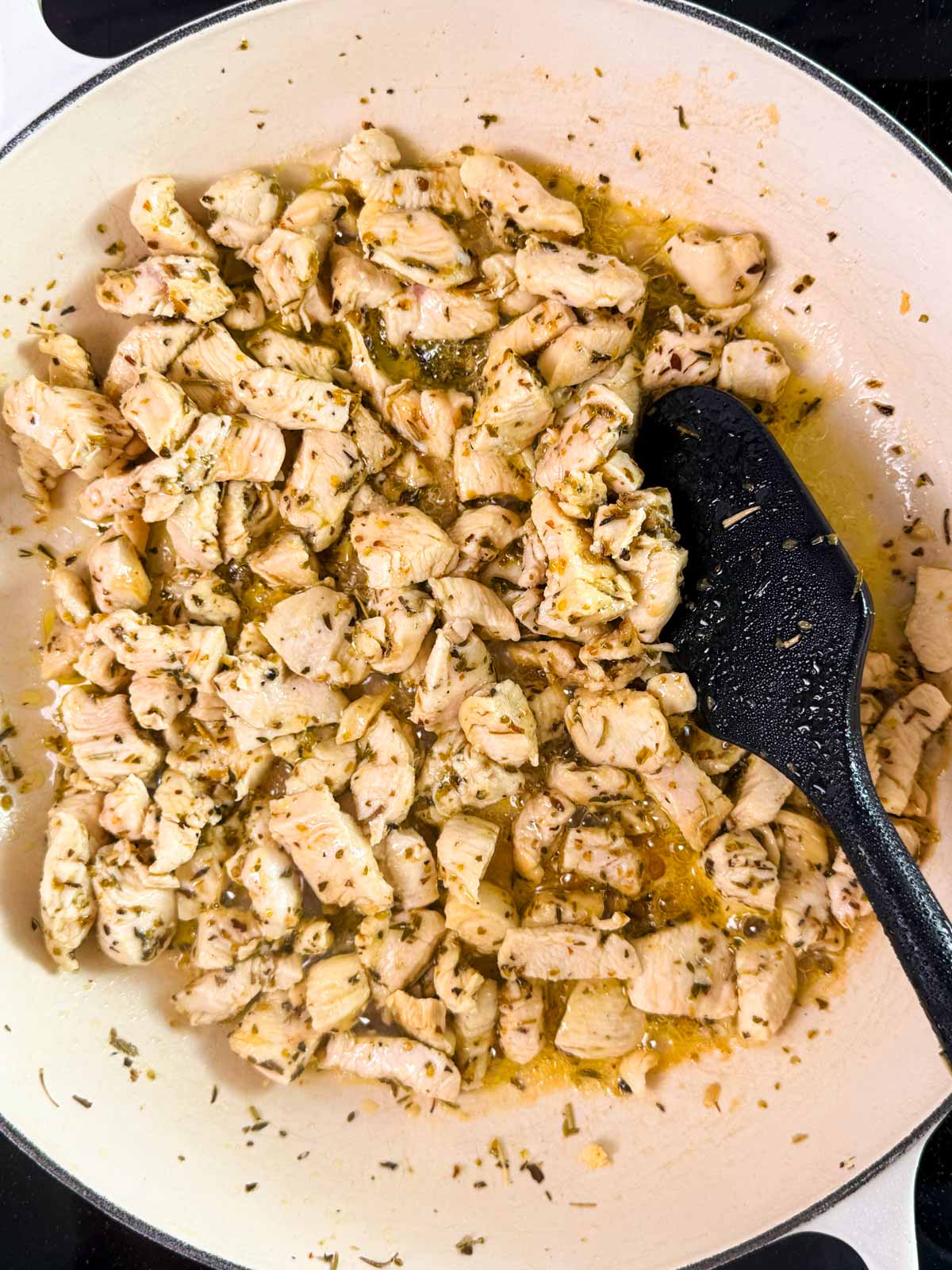 Seared chicken bites in a skillet.