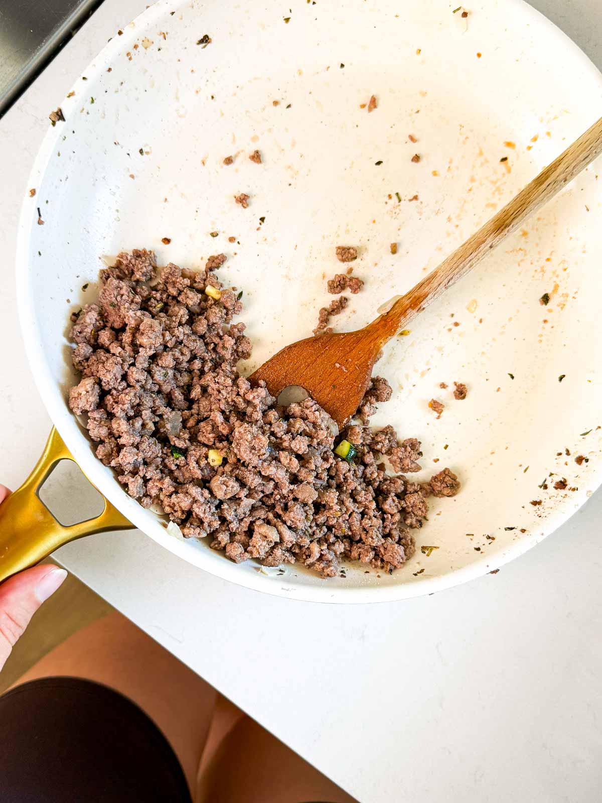 Ground beef browned in skillet.