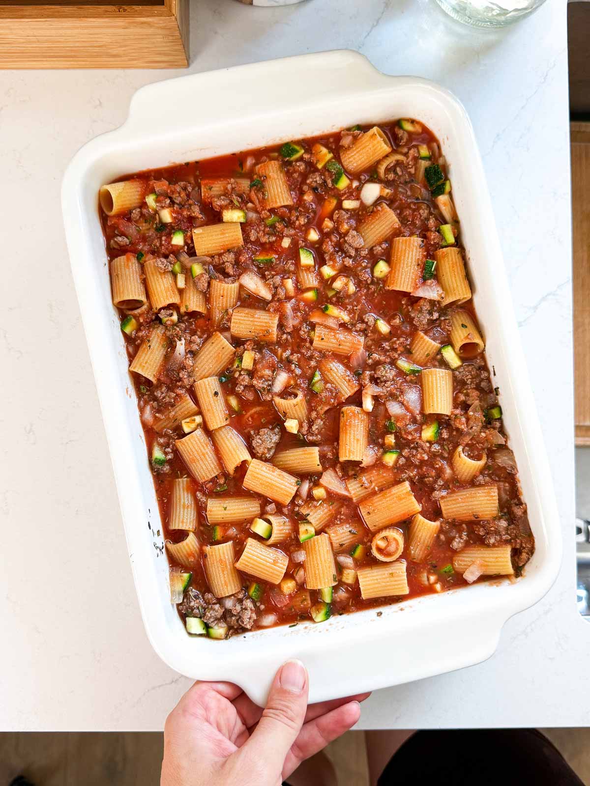 Unbaked zucchini and ground beef pasta casserole.