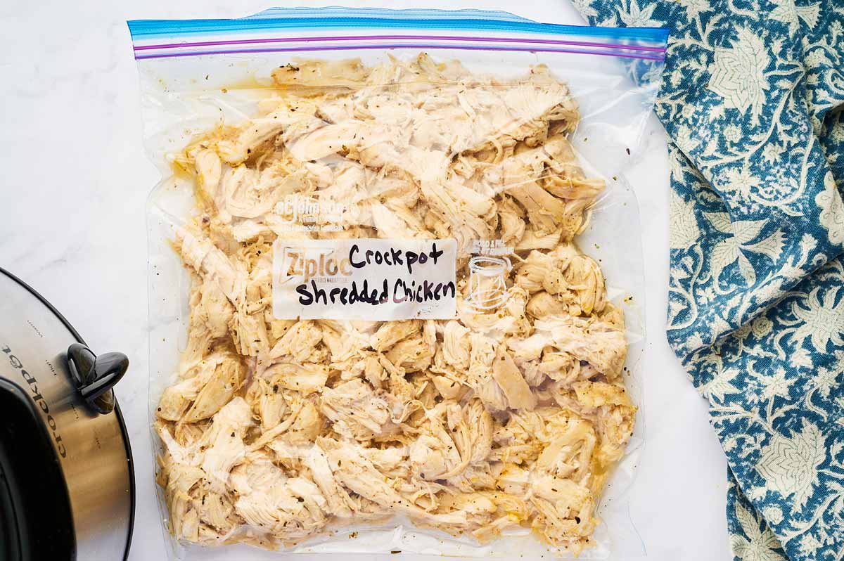Shredded chicken in a zip-top bag labeled for freezing.