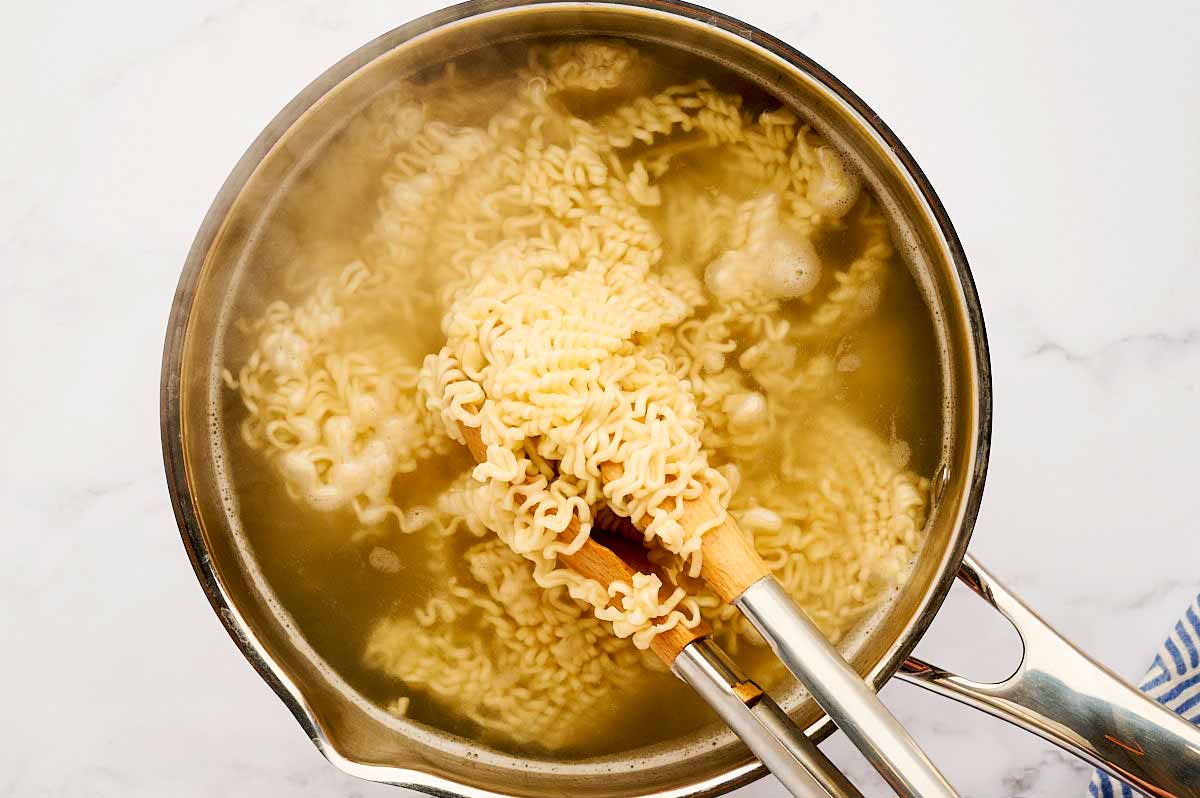 Cooking ramen noodles in a pot of water.