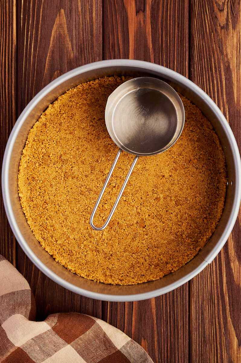 Gingersnap crust in a springform pan.