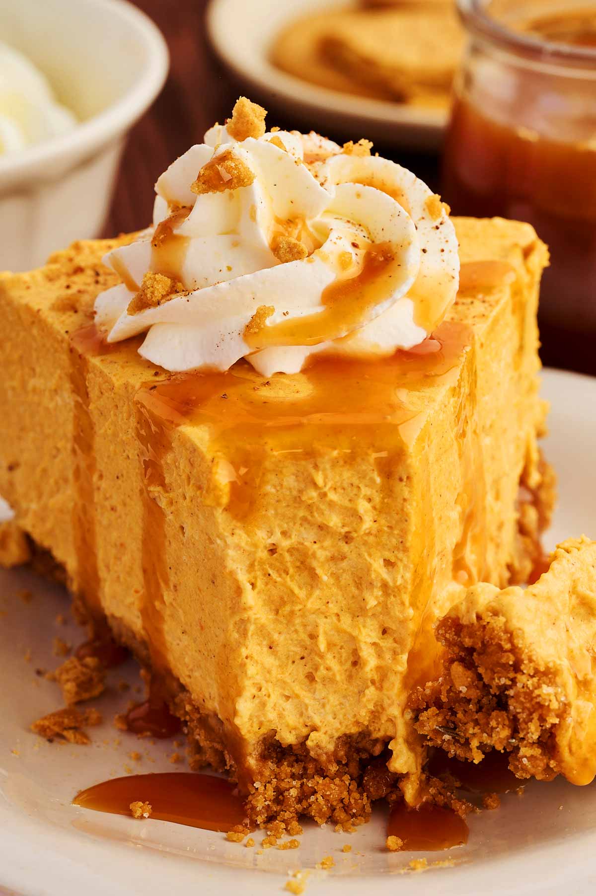 Frontal view of a slice of no bake pumpkin cheesecake.