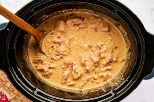 Uncooked chicken curry in slow cooker.