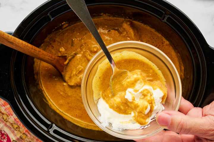 Tempering yogurt to add to chicken curry in a slow cooker.