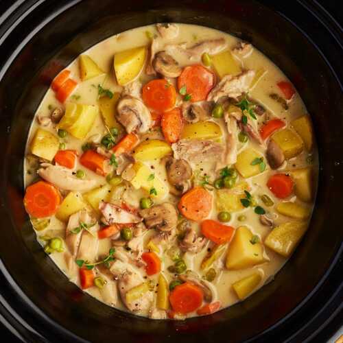Slow cooker with chicken stew inside.