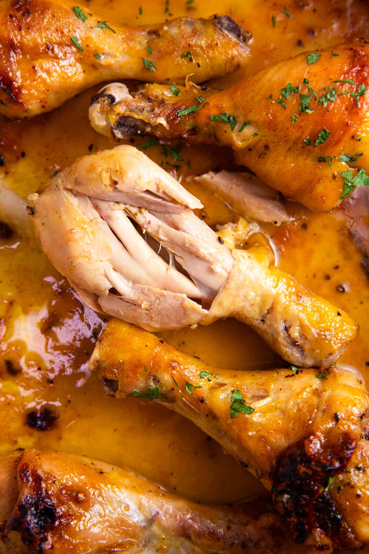 Close up photo of an opened baked chicken leg.