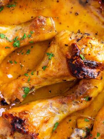 Close up photo of oven baked chicken leg.