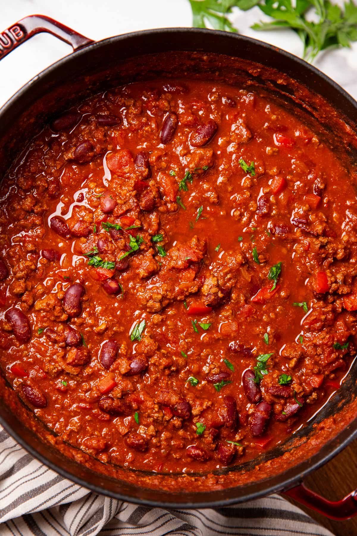 Chili being served in a cast iron pot.