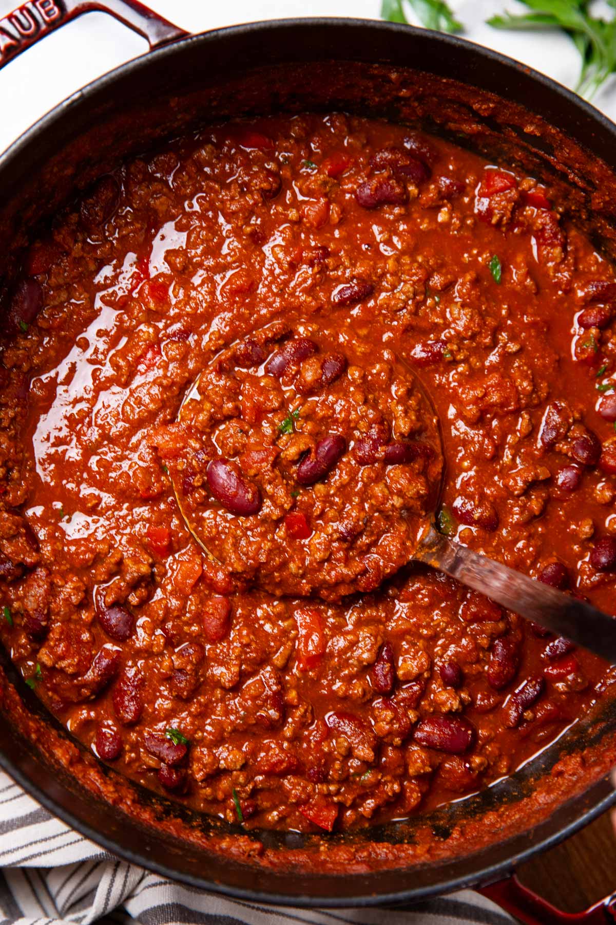 Pot of chili with ladle inside.