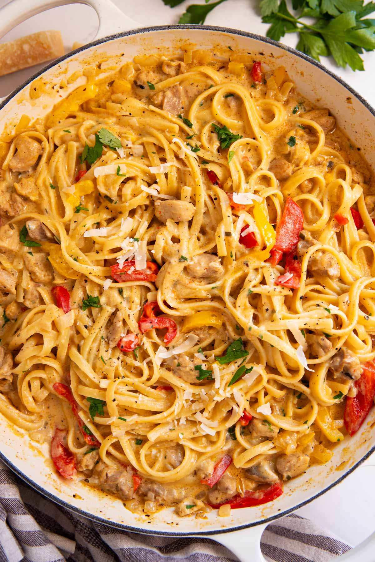 Overhead view of an enameled cast iron pan filled with Creamy Cajun Chicken Pasta.