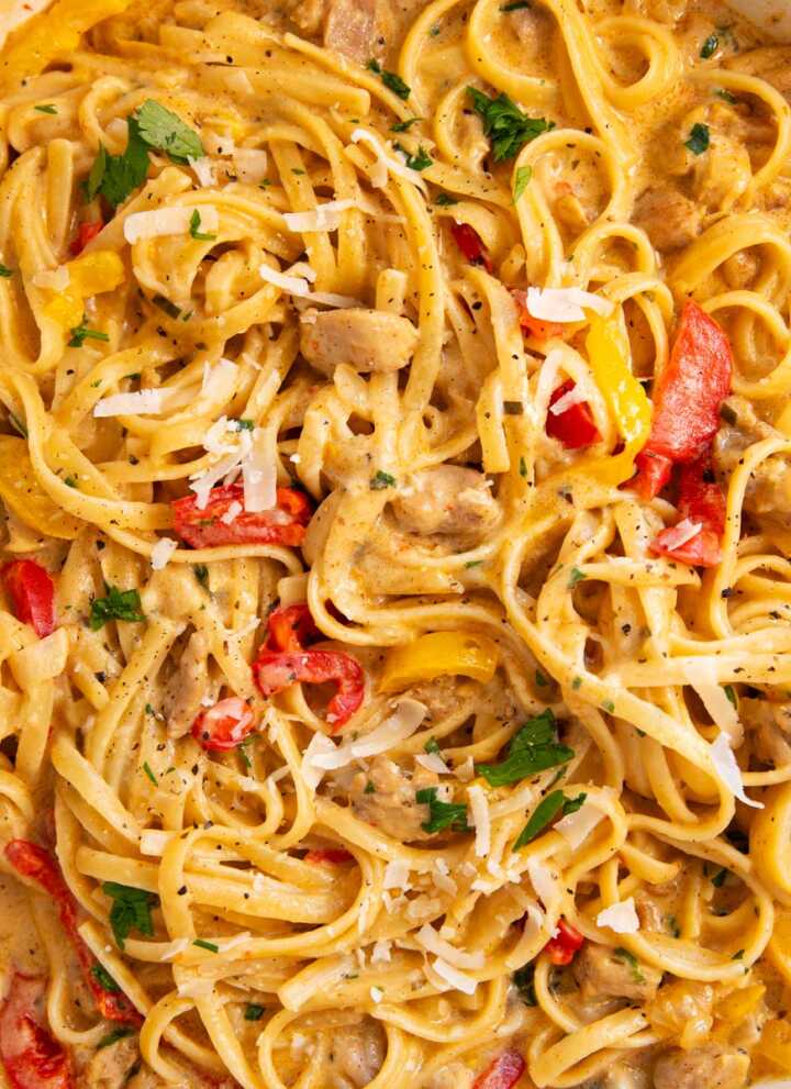 Overhead view of an enameled cast iron pan filled with Creamy Cajun Chicken Pasta.