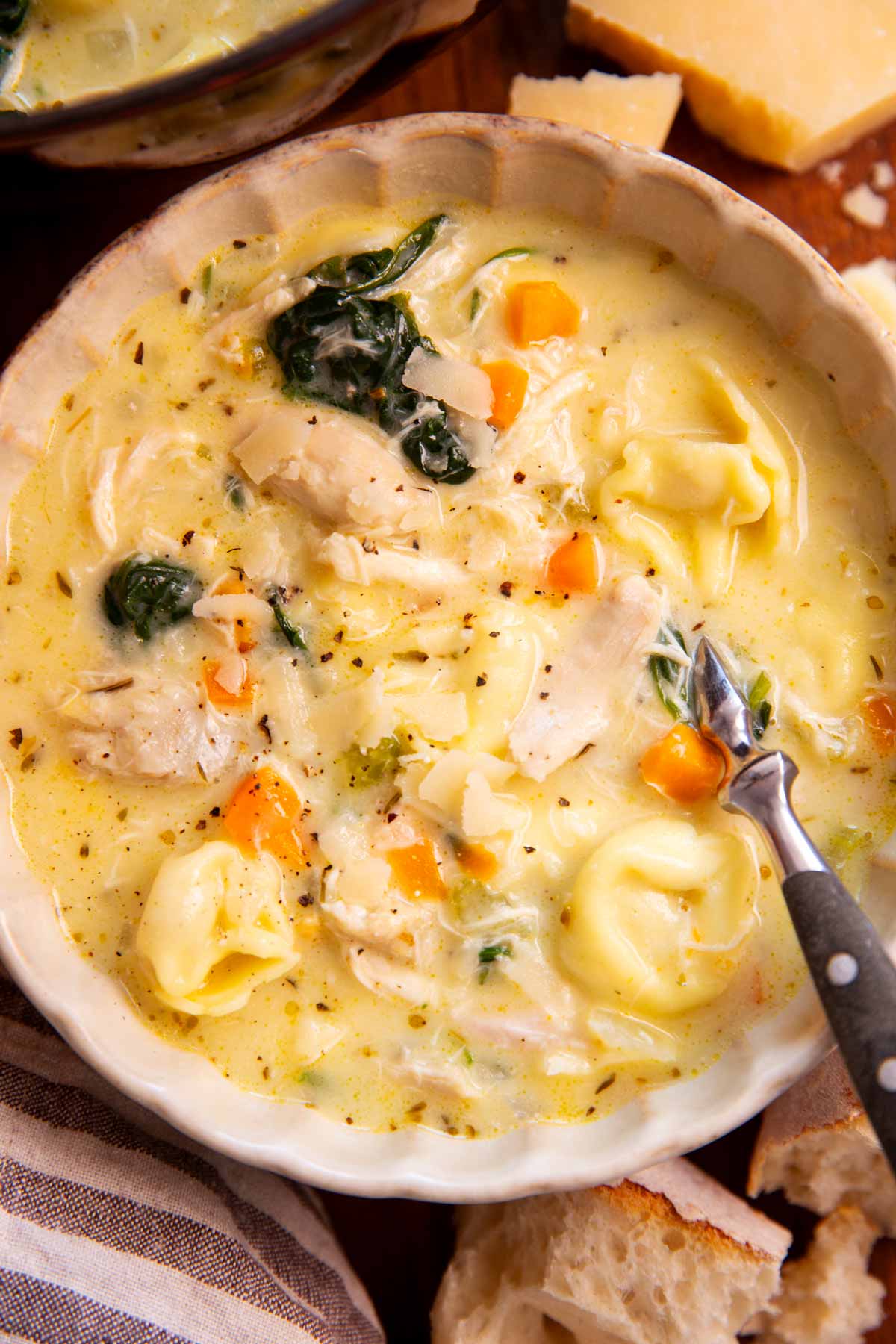 Bowl filled with creamy chicken tortellini soup.