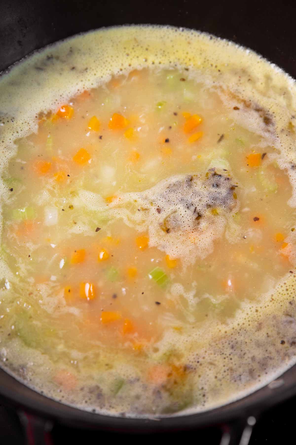 Soup simmering in a cast iron pot.