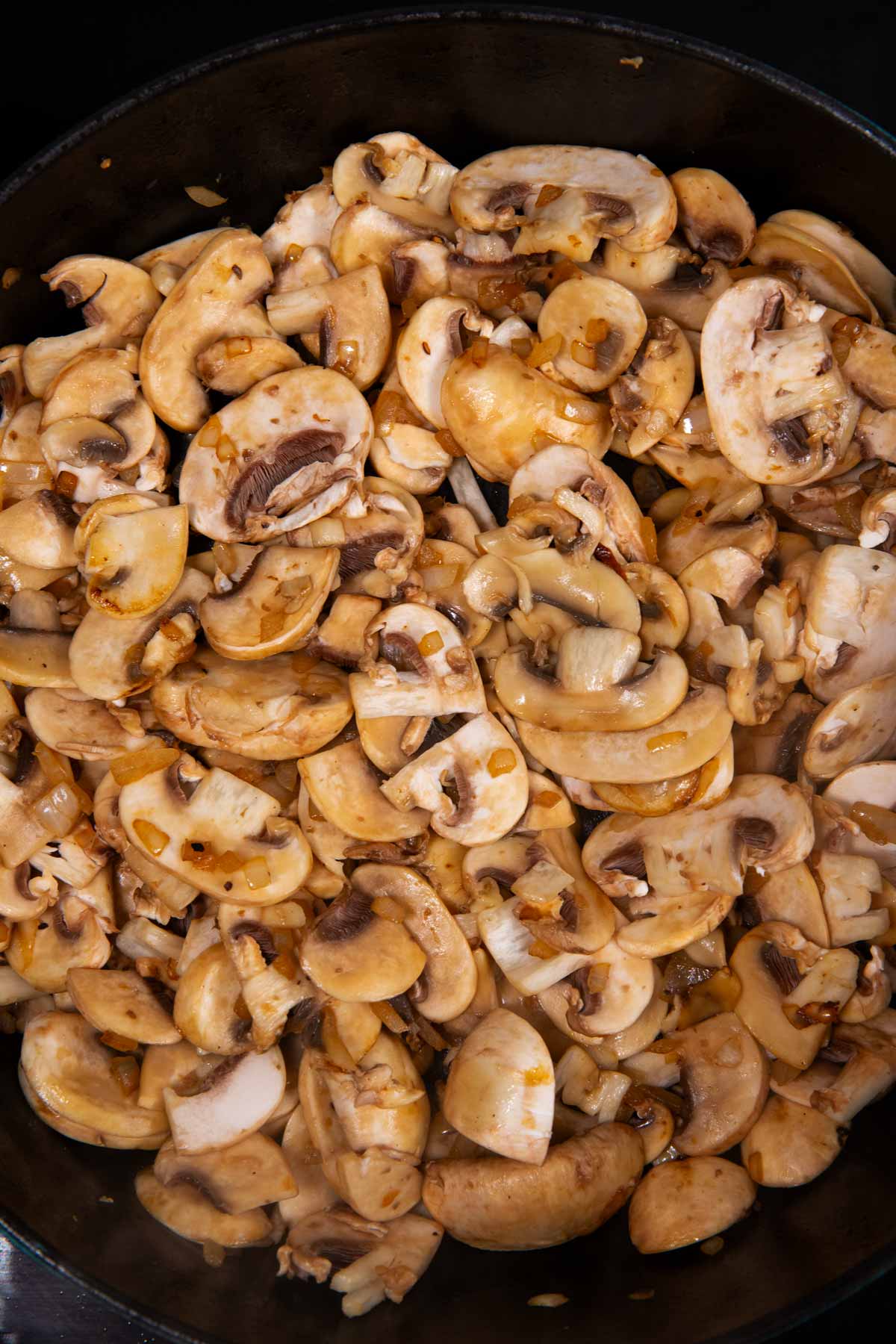 Cooking mushrooms in skillet.