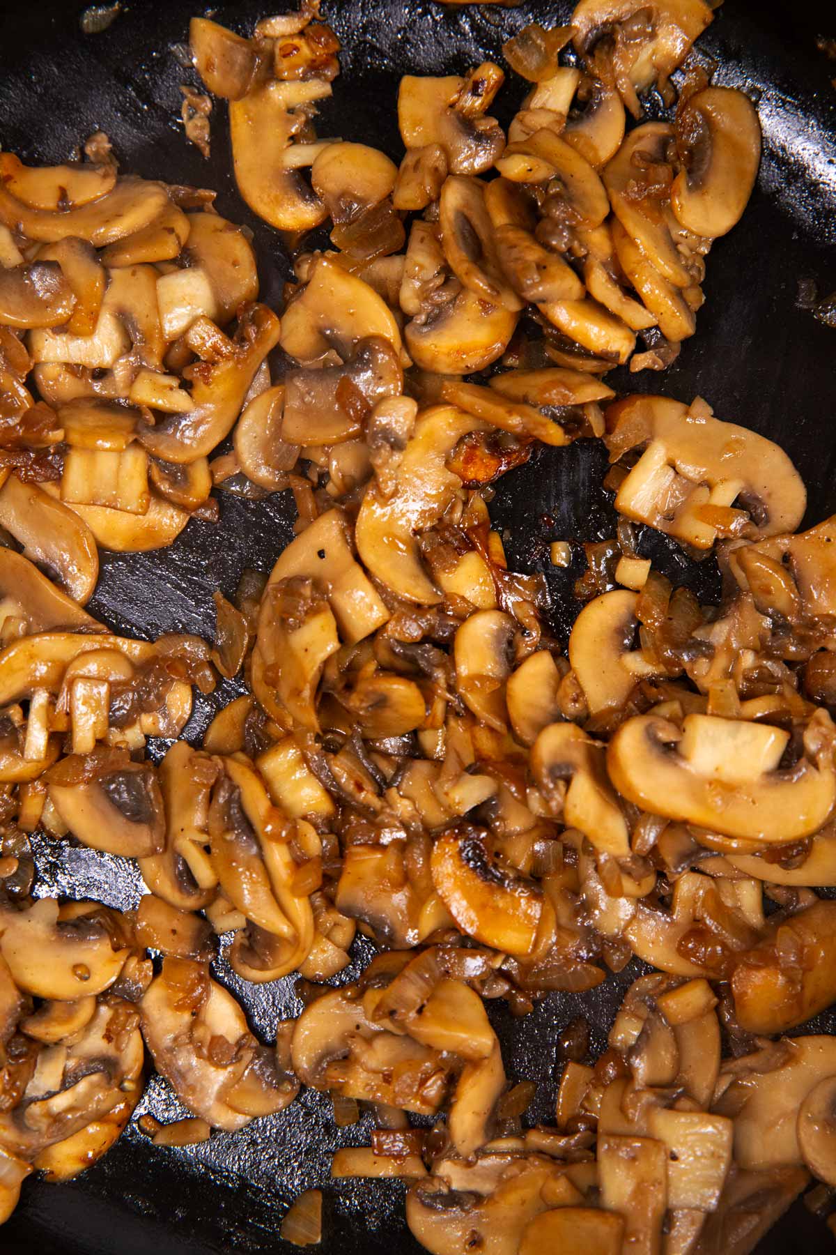 Cooked mushrooms in a cast iron skillet.