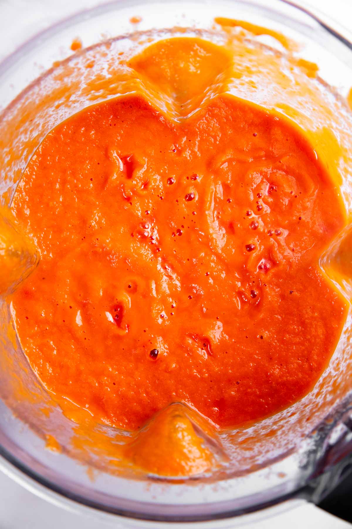 Tomato soup blended in blender cup.
