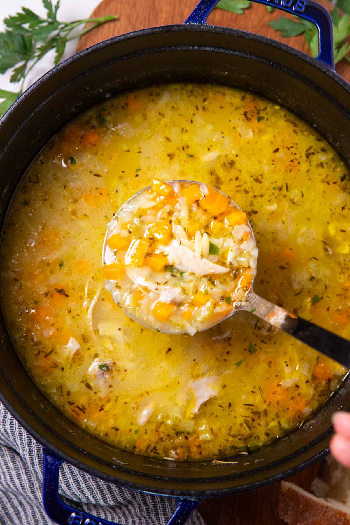 Cast iron pot with lemon chicken orzo soup.